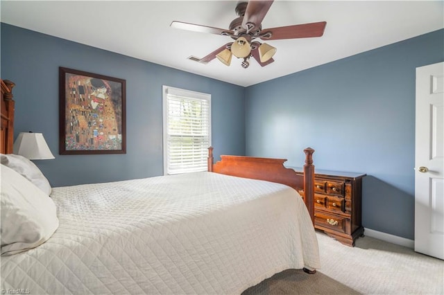carpeted bedroom featuring visible vents, a ceiling fan, and baseboards