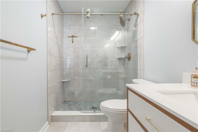 bathroom featuring a shower stall, toilet, vanity, and tile patterned floors