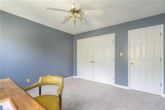 home office with baseboards, a ceiling fan, and carpet flooring