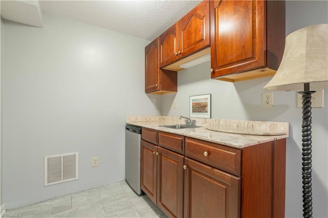 kitchen with visible vents, stainless steel dishwasher, a sink, light stone countertops, and a textured ceiling