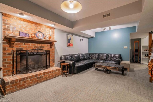 living area featuring a brick fireplace, carpet floors, and visible vents