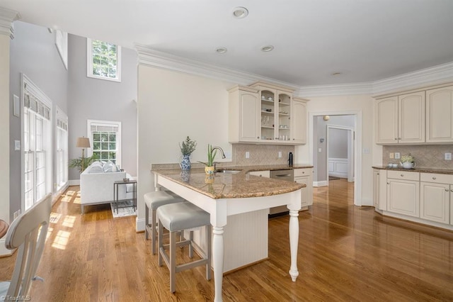 5000 Casting Way, Greensboro, NC 27455 - kitchen with cream cabinetry, a kitchen breakfast bar, dishwasher, plenty of natural light, and ornamental molding