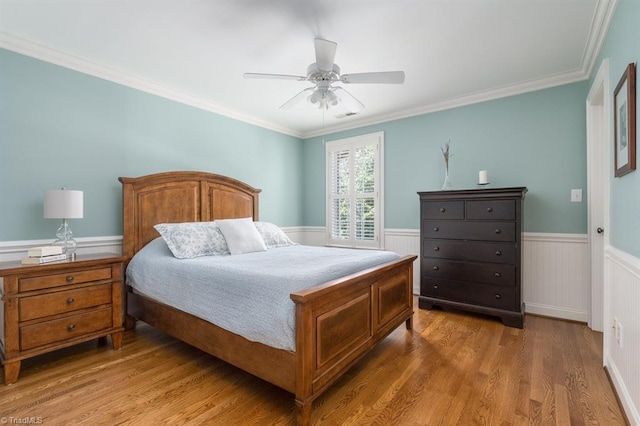 5000 Casting Way, Greensboro, NC 27455 - bedroom with wainscoting, wood finished floors, ornamental molding, and ceiling fan