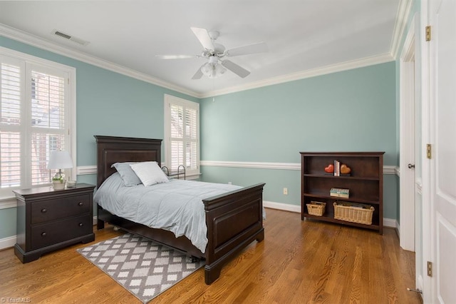 5000 Casting Way, Greensboro, NC 27455 - bedroom featuring ornamental molding, wood finished floors, and a ceiling fan