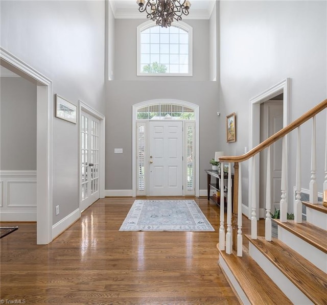 5000 Casting Way, Greensboro, NC 27455 - foyer with healthy amount of natural light, crown molding, a chandelier, stairs, and wood finished floors