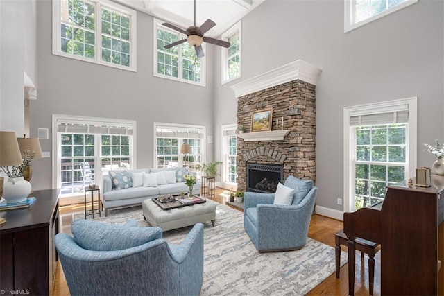 5000 Casting Way, Greensboro, NC 27455 - living room with a towering ceiling, a ceiling fan, wood finished floors, and a stone fireplace