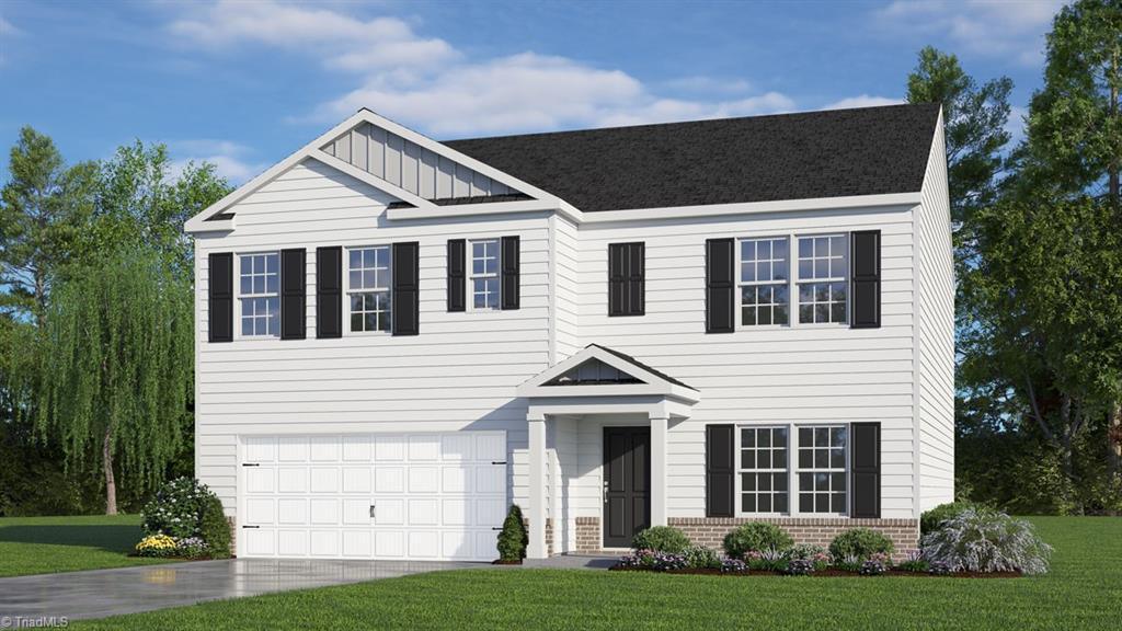 view of front of property featuring a front yard and a garage