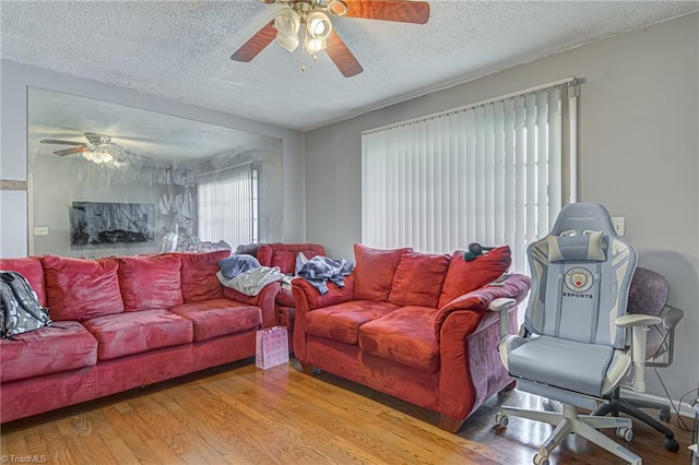 living room featuring a textured ceiling and hardwood / wood-style floors