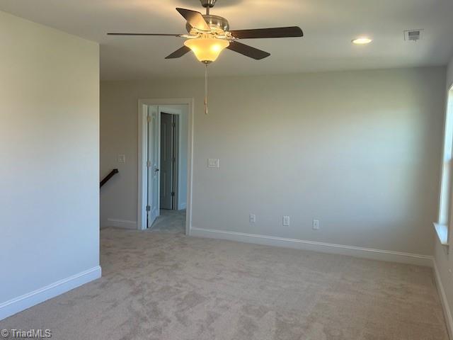 carpeted empty room with ceiling fan