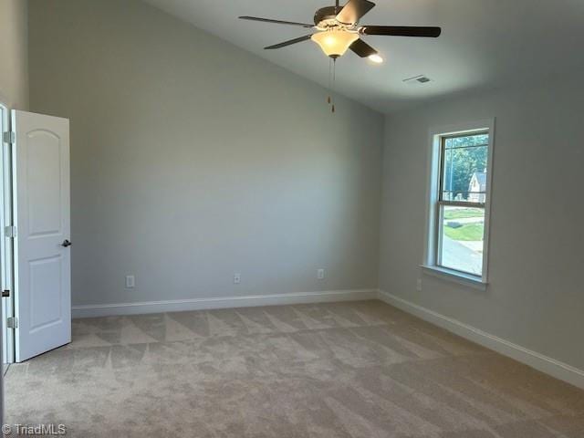 spare room with light carpet, high vaulted ceiling, and ceiling fan