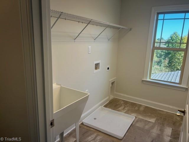 laundry area featuring hookup for a washing machine, hookup for an electric dryer, a healthy amount of sunlight, and hardwood / wood-style flooring