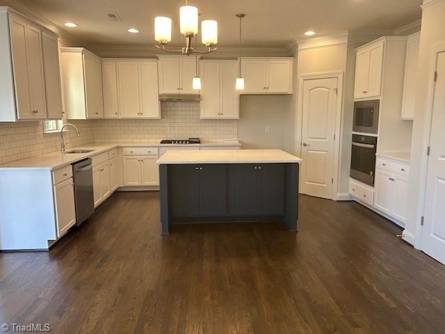 kitchen featuring sink, black appliances, hanging light fixtures, a kitchen island, and white cabinets