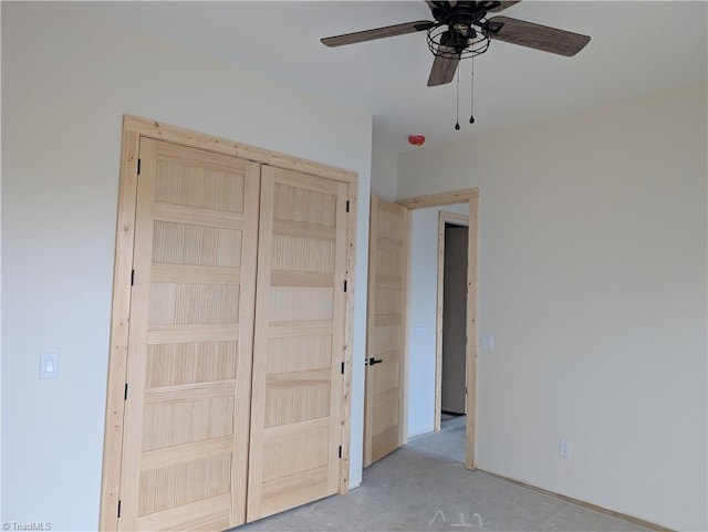 unfurnished bedroom featuring a closet, concrete floors, and ceiling fan