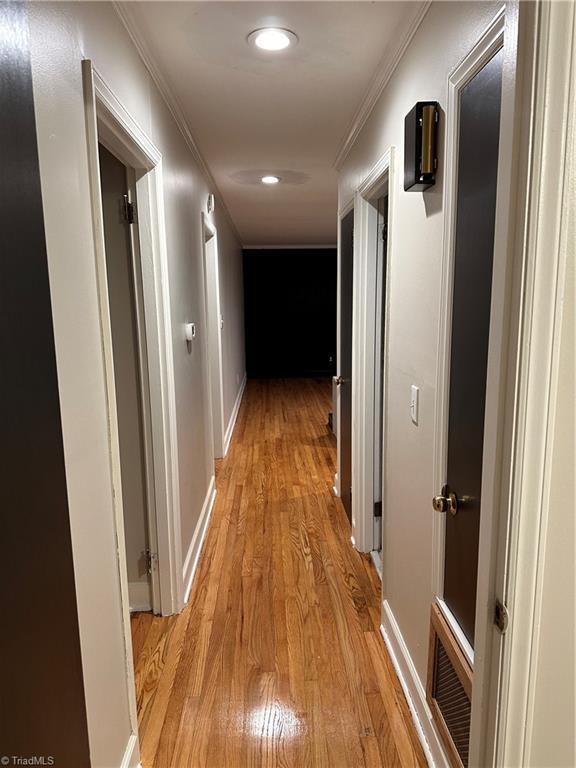 702 Trail One, Burlington, NC 27215 - corridor featuring light wood-type flooring, ornamental molding, recessed lighting, and baseboards