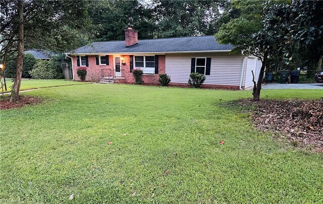 702 Trail One, Burlington, NC 27215 - single story home featuring a chimney, a front yard, and brick siding