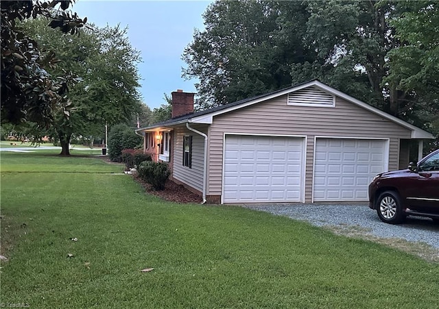 702 Trail One, Burlington, NC 27215 - view of property exterior featuring a chimney, a detached garage, and a yard