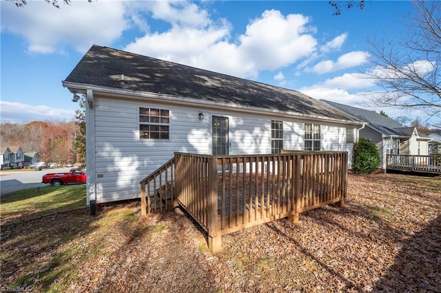 back of property with a wooden deck