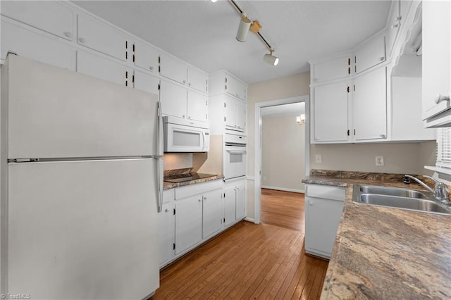 2206 Revolan Dr, Greensboro, NC 27407 - kitchen with white appliances, light wood-type flooring, and white cabinetry