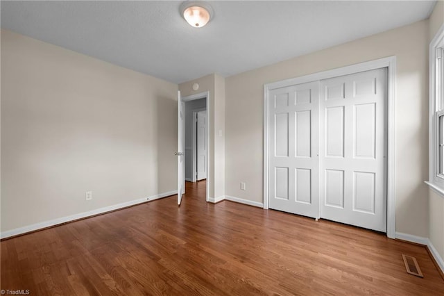 2206 Revolan Dr, Greensboro, NC 27407 - unfurnished bedroom featuring wood finished floors and a closet