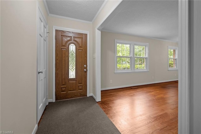 2206 Revolan Dr, Greensboro, NC 27407 - entryway featuring ornamental molding, wood finished floors, and a textured ceiling