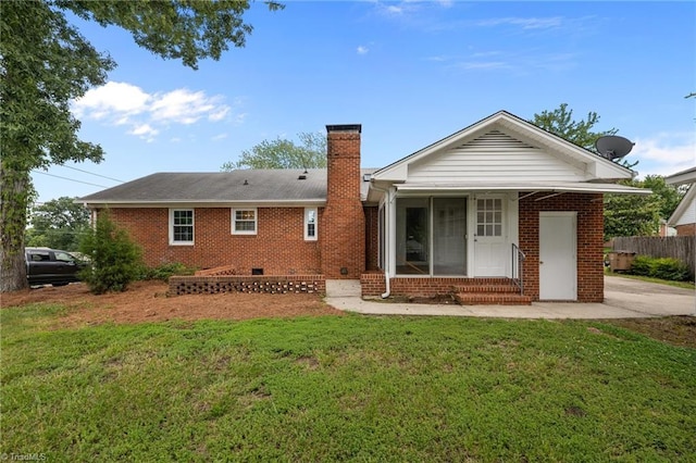 2206 Revolan Dr, Greensboro, NC 27407 - rear view of property featuring a chimney, brick siding, entry steps, and crawl space