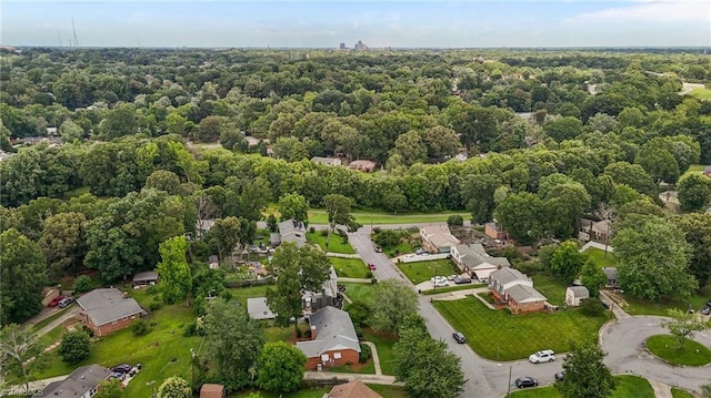2206 Revolan Dr, Greensboro, NC 27407 - aerial view of property and surrounding area featuring a heavily wooded area and nearby suburban area