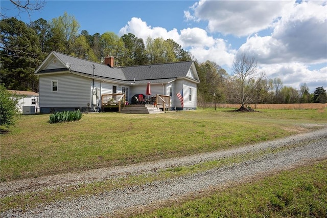 4724 Old Julian Rd, Julian, NC 27283 - rear view of property with a chimney, a deck, a yard, and gravel driveway