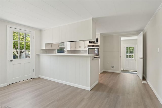 1616 Sanford Dr, Winston-Salem, NC 27105 - kitchen featuring light countertops, appliances with stainless steel finishes, a wealth of natural light, and light wood finished floors