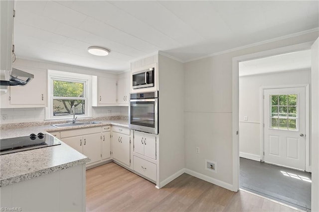 1616 Sanford Dr, Winston-Salem, NC 27105 - kitchen featuring light countertops, appliances with stainless steel finishes, a healthy amount of sunlight, and a sink