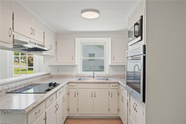 1616 Sanford Dr, Winston-Salem, NC 27105 - kitchen featuring light countertops, a sink, under cabinet range hood, and stainless steel appliances