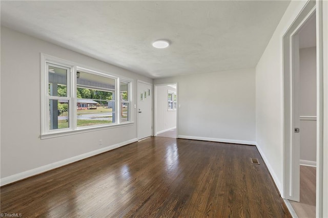 1616 Sanford Dr, Winston-Salem, NC 27105 - spare room with baseboards, wood finished floors, and visible vents