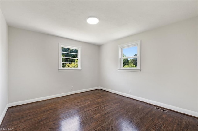 1616 Sanford Dr, Winston-Salem, NC 27105 - spare room with baseboards, dark wood-style flooring, and visible vents