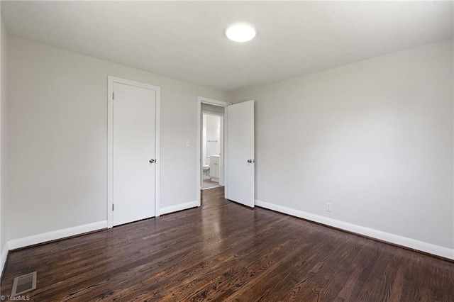 1616 Sanford Dr, Winston-Salem, NC 27105 - unfurnished bedroom featuring baseboards, dark wood finished floors, and visible vents