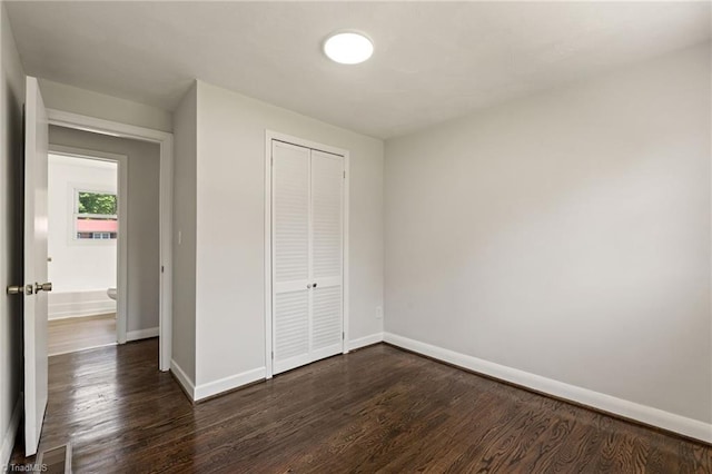 1616 Sanford Dr, Winston-Salem, NC 27105 - unfurnished bedroom with baseboards, dark wood finished floors, and a closet