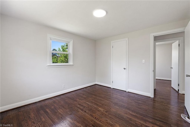 1616 Sanford Dr, Winston-Salem, NC 27105 - unfurnished bedroom featuring baseboards and dark wood finished floors