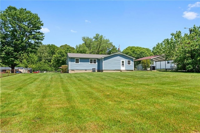 1616 Sanford Dr, Winston-Salem, NC 27105 - back of house featuring a lawn and a detached carport