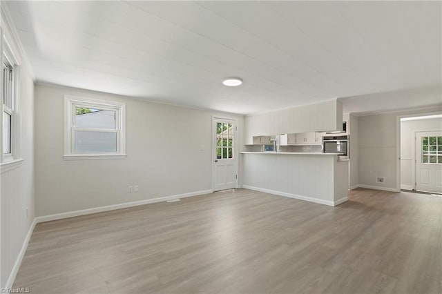 1616 Sanford Dr, Winston-Salem, NC 27105 - unfurnished living room featuring light wood-style floors and baseboards