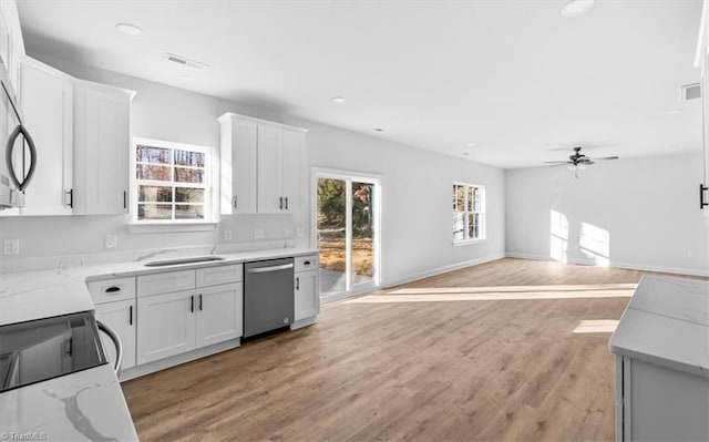 kitchen with white cabinets, ceiling fan, dishwasher, and light stone counters