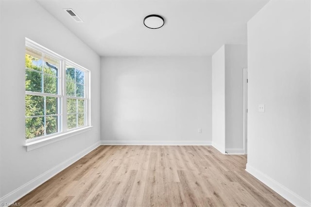 spare room featuring light wood-type flooring