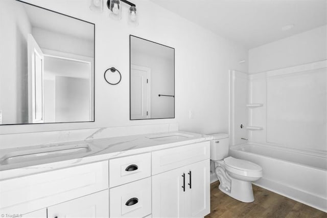 full bathroom with toilet, vanity, hardwood / wood-style floors, and shower / tub combination