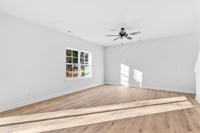 spare room with ceiling fan and light hardwood / wood-style flooring