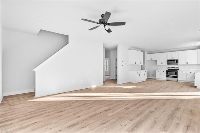 unfurnished living room with ceiling fan and light hardwood / wood-style flooring