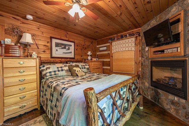 612 Joe Shoemaker Rd, Vilas, NC 28692 - bedroom featuring wood ceiling, hardwood / wood-style flooring, a fireplace, and wooden walls
