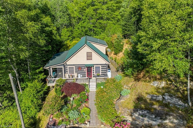 612 Joe Shoemaker Rd, Vilas, NC 28692 - view of front of house with solar panels, a deck, and a forest view