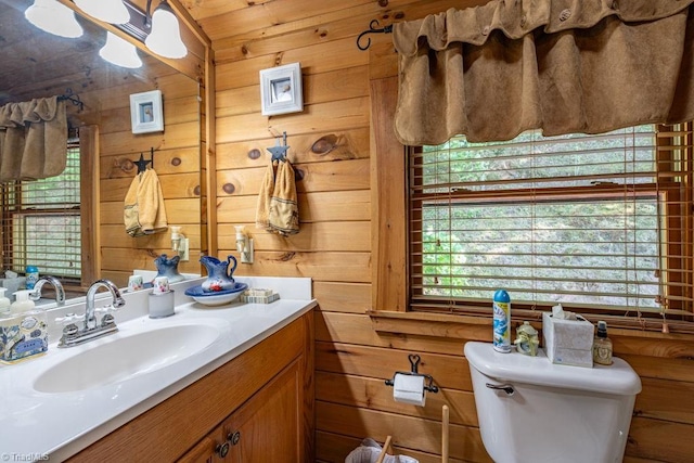 612 Joe Shoemaker Rd, Vilas, NC 28692 - bathroom featuring toilet, vanity, wooden walls, and plenty of natural light