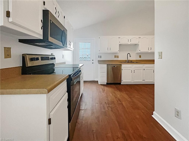 kitchen featuring lofted ceiling, sink, white cabinetry, stainless steel appliances, and dark hardwood / wood-style flooring