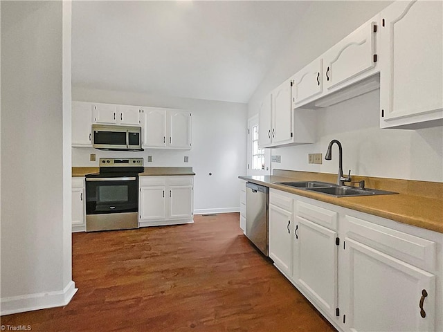 kitchen featuring appliances with stainless steel finishes, sink, and white cabinetry