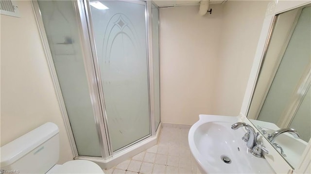 bathroom with sink, toilet, a shower with shower door, and tile patterned flooring