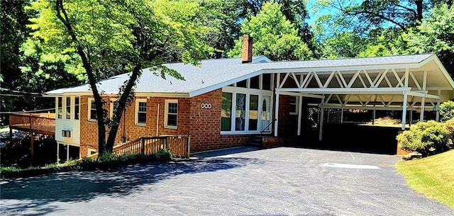 view of front of property featuring a carport