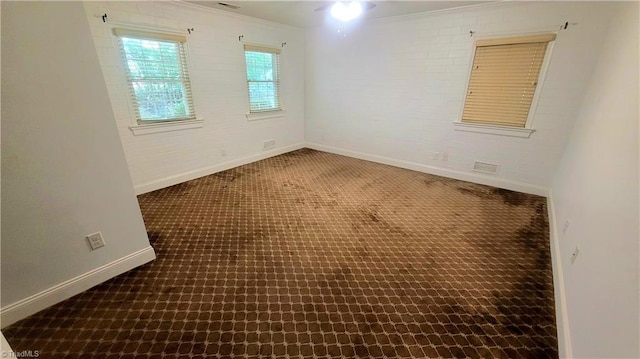 carpeted spare room with crown molding